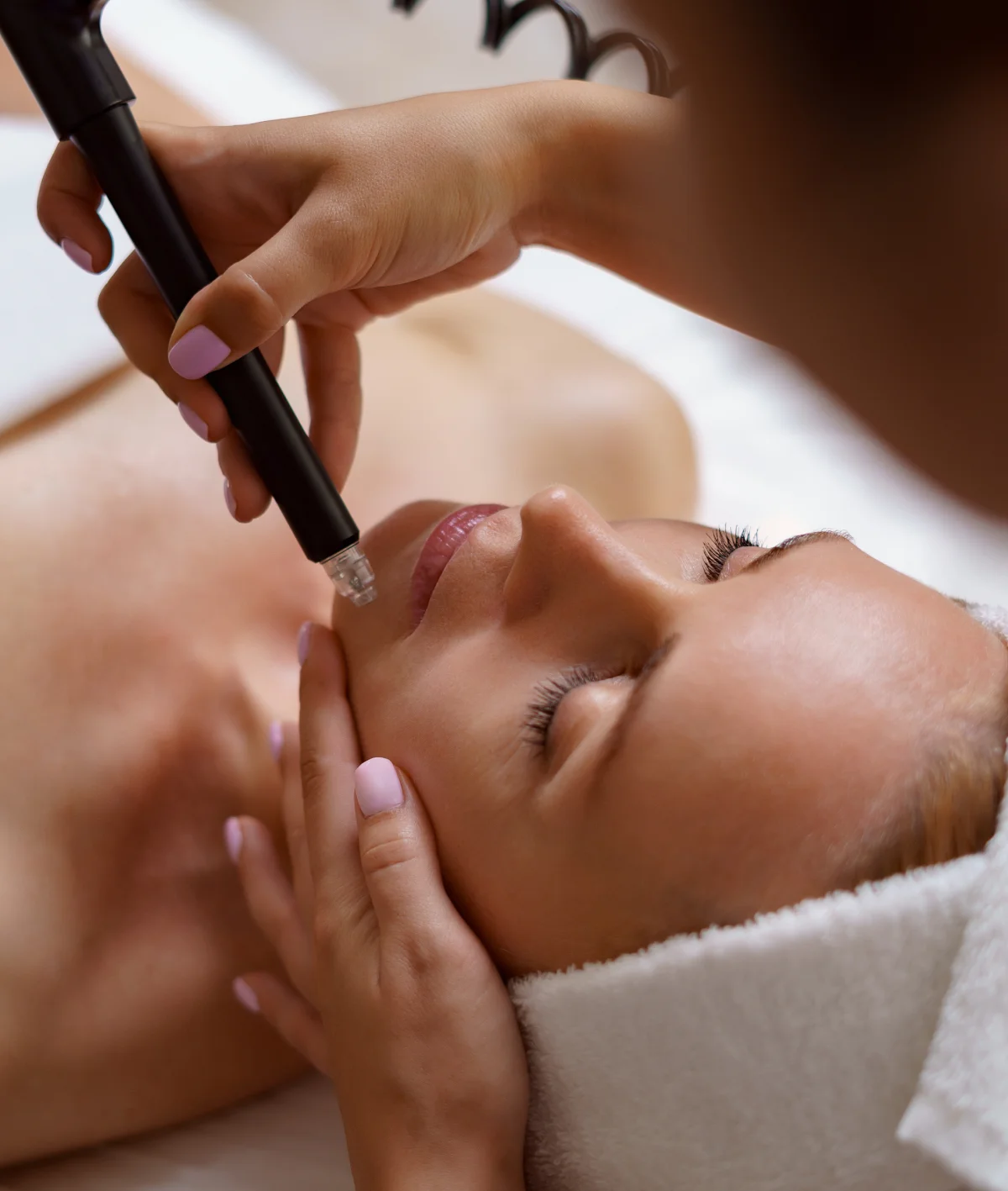 HydraFacial treatment being performed on a client's face